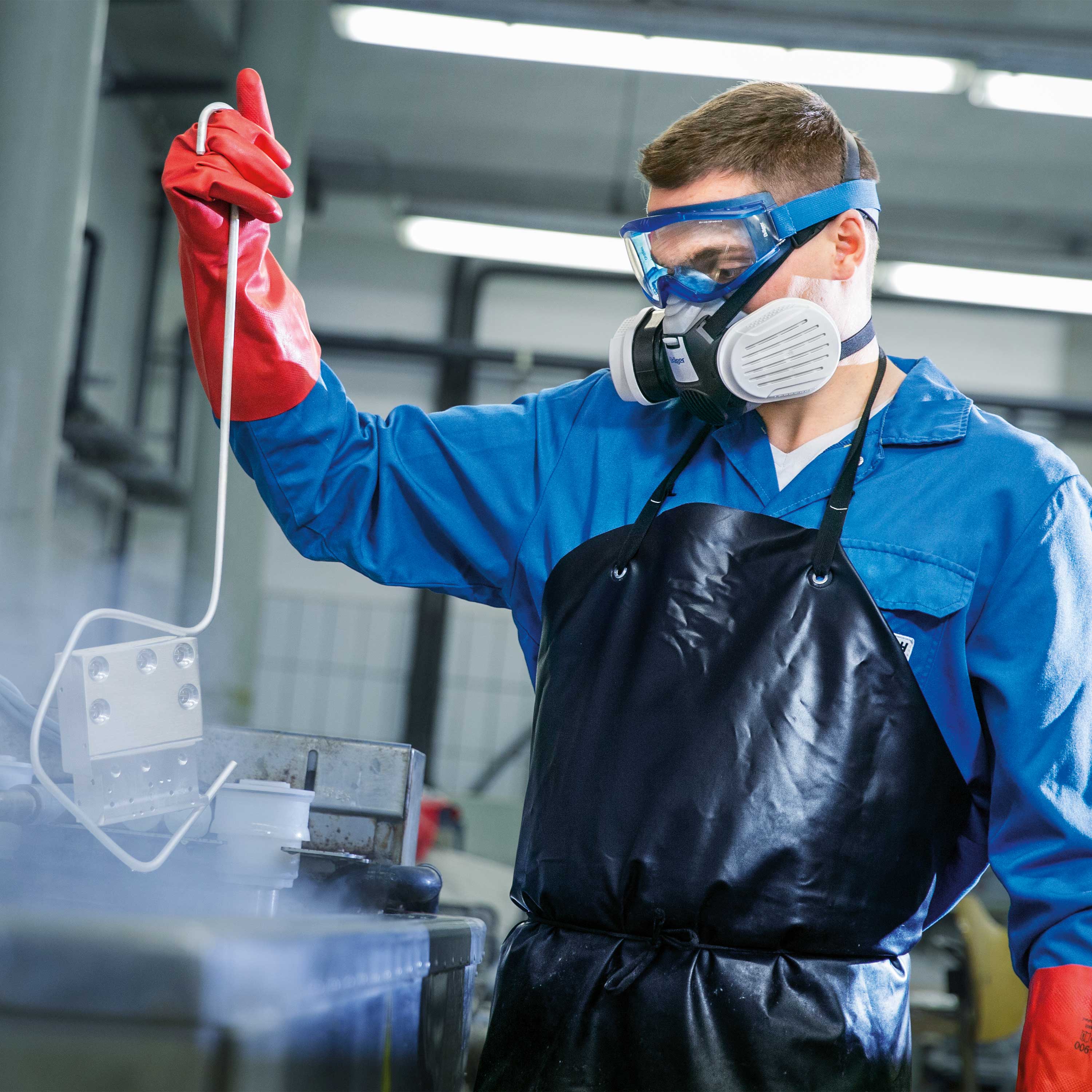 Arbeiter trägt Schutzkleidung und Halbmaske X-plore 3300.