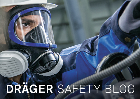 Geschützter Arbeiter bei Dräger Safety Mann mit Schutzmaske und Helm in Sicherheitskleidung