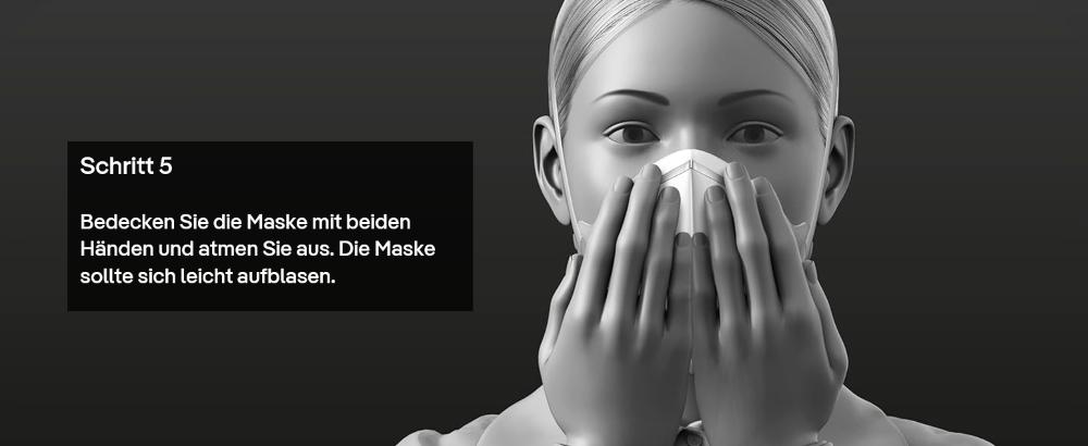 Staubmaske mit beiden Händen bedecken und ausatmen.