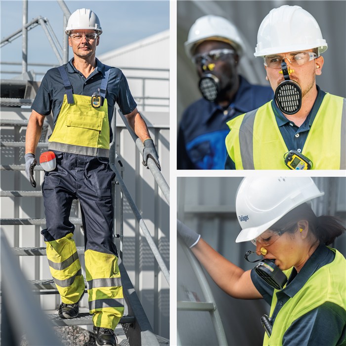 Sicherheitstechnik im Industrieeinsatz Personen tragen Schutzbekleidung und Helme auf Industriegelände.